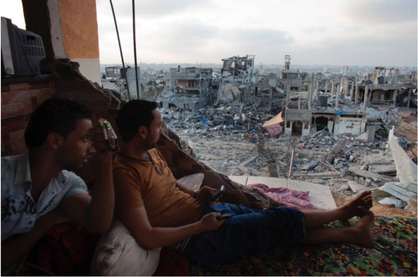 Palestinians look at the Shejaya neighborhood of Gaza City